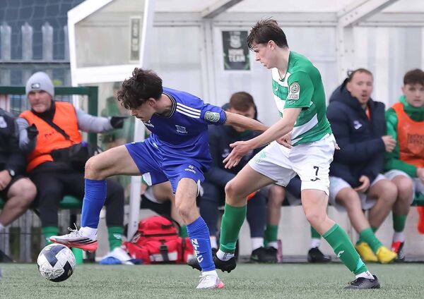 Newbridge Town's Shane O'Keeffe under pressure from Villa's Conor Kilgannon.