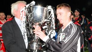 <p>TJ Moore receives the Lumsden Cup from KDFL Chairman Michael Casey after Coill Dubh beat Clane Utd in the 2010 Lumsden Cup. Photo: Coill Dubh AFC</p> <p>TJ Moore receives the Lumsden Cup from KDFL Chairman Michael Casey after Coill Dubh beat Clane Utd in the 2010 Lumsden Cup. Photo: Coill Dubh AFC</p>
