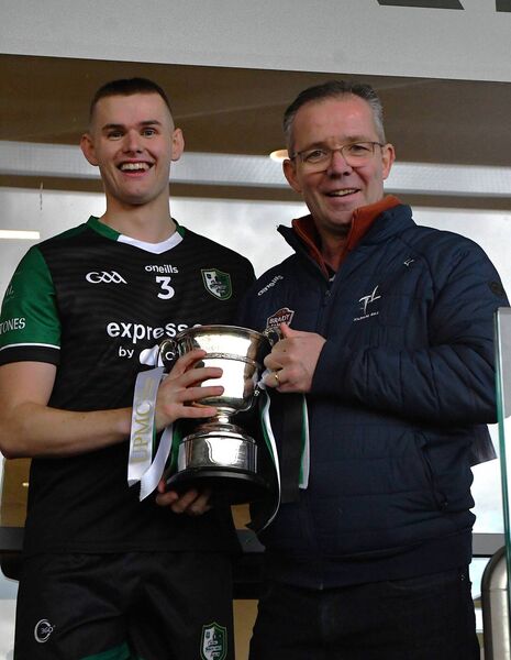 County board vice-chairman Larry Curtin presents the Junior Hurling Championship trophy to Wolfe Tones captain Ciaran O'Gorman Photo: Michael Anderson County board vice-chairman Larry Curtin presents the Junior Hurling Championship trophy to Wolfe Tones captain Ciaran O'Gorman Photo: Michael Anderson