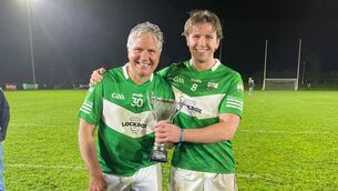 <p>Father and son combination, Darragh and Ruairi Byrne celebrate Rathangan's newly won Junior 'A' Hurling title.</p>