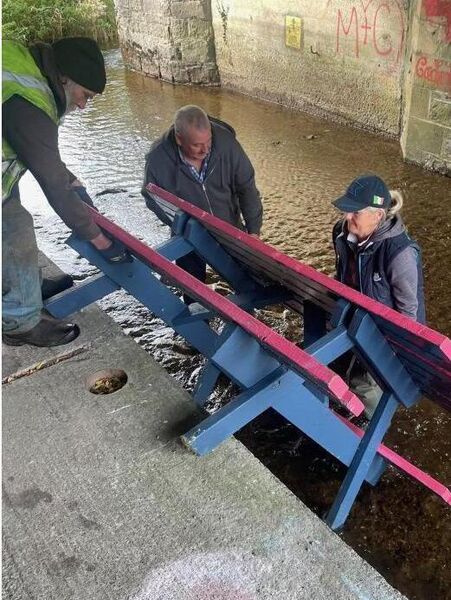 KCA workers recovering a table thrown into the river