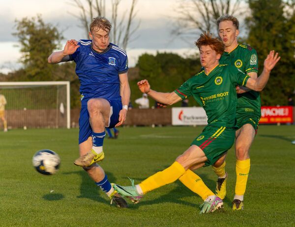 CK United’s Daniel McGrath clears from Newbridge Town’s Ruairi Brown. Photo: Michael O'Rourke 