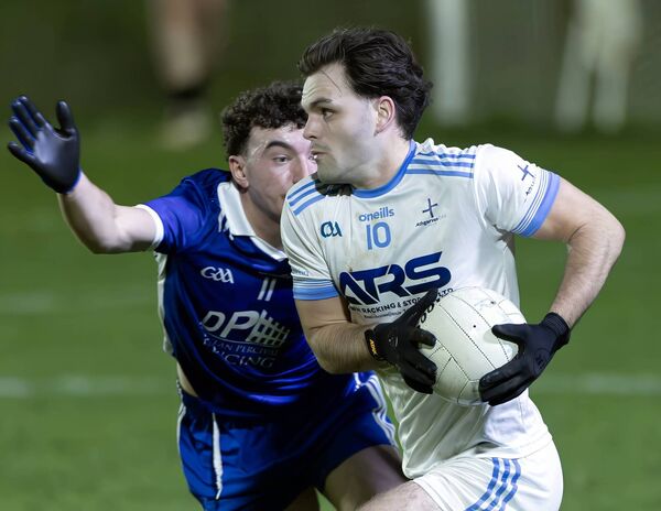 Athgarvan's Cian Doyle comes under pressure from Robertstown's Aidan Gillen.